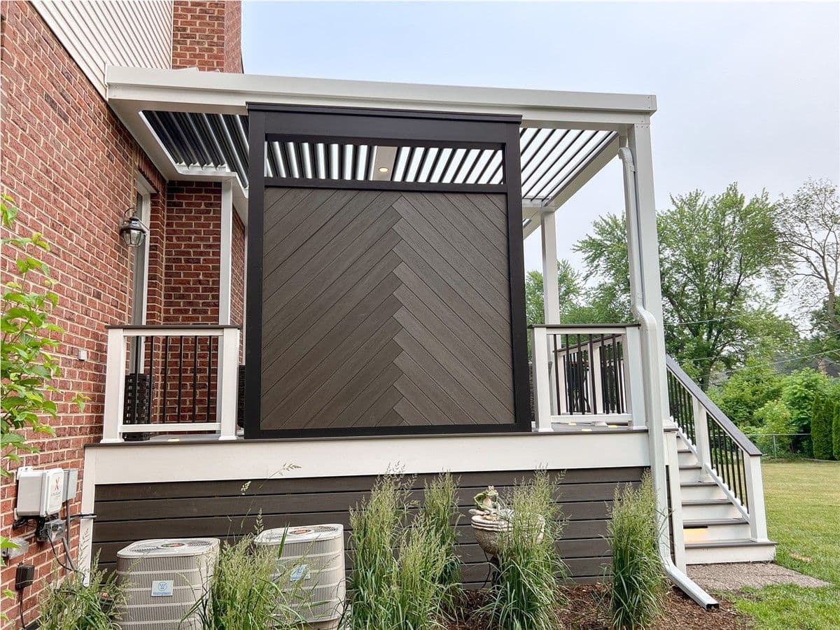 A custom privacy wall attached to a white pergola.
